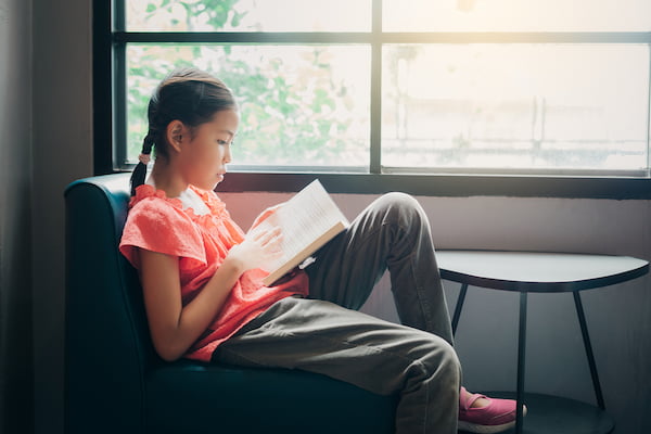 girl sitting and reading a book